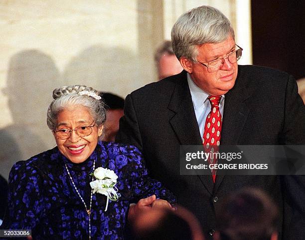 Civil rights heroine Rosa Parks is escorted by US House Speaker Dennis Hastert as she arrives for ceremonies 15 June 1999, in the Rotunda at the US...