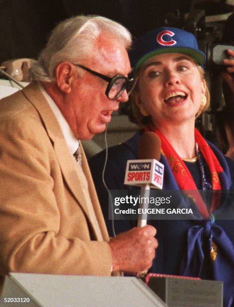 First Lady Hillary Rodham Clinton sings "Take Me Out to the Ballgame" with Chicago Cubs television announcer Harry Caray 04 April during their game...