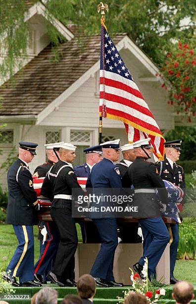 Military honor guard carries former President Richard M. Nixon's flag-draped casket past the house in which he was born, during the late president's...