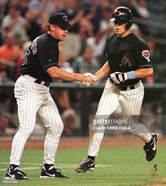 Arizona Diamondbacks' Jay Bell is congratulated by third base coach Brian Butterfield after he hit his 22nd homer of the season against the Atlanta...