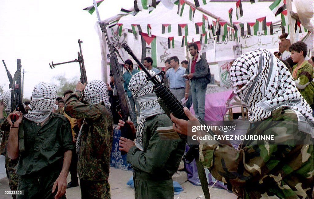 Members of the Fatah movement shoot in the air dur