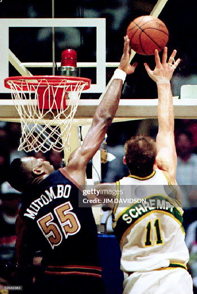 Denver Nuggets Dikembe Mutombo (L) blocks the shot