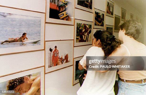 Members of Ayrton Senna's fan club view pictures of him and mourn 01 May 1994 in Sao Paulo, Brazil after Senna was killed in a crash at the San...