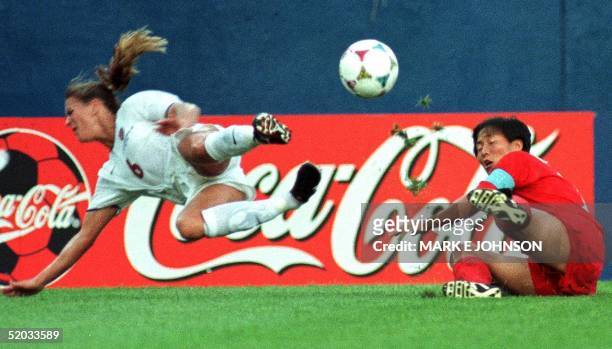 Brandi Chastain of the US and Kum Sil Kim of North Korea battle for a ball in the first half of their 1999 FIFA Women's World Cup match at Foxboro...