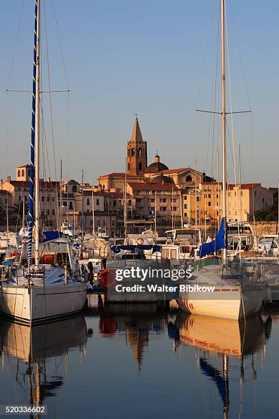 alghero, city walls from the yacht marina - alghero stock pictures, royalty-free photos & images