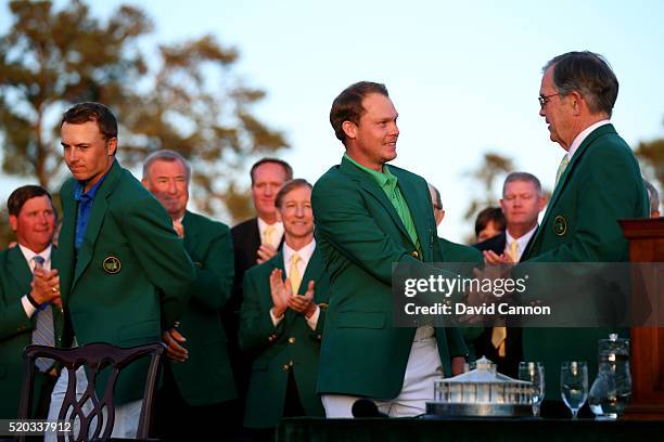 Danny Willett of England shakes hands with Chairman of Augusta National, William Porter Payne as Jordan Spieth of the United States looks on after...