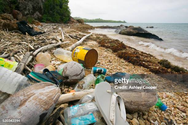 litter on beach on malolo island - plastic pollution beach stock pictures, royalty-free photos & images