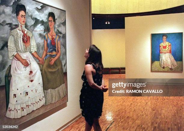 Visitor at the Modern Art Museum of Mexico City looks at a double auto-portrait by Mexican artist Frida Kahlo 22 August 1999.