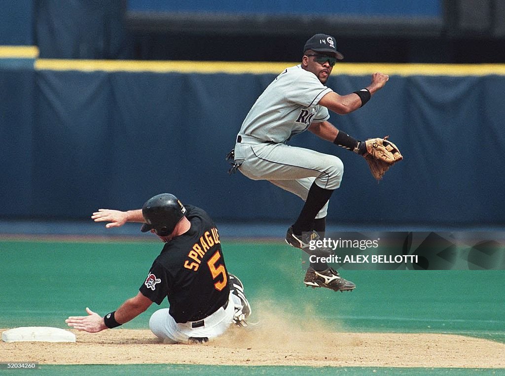 Colorado Rockies' Neifi Perez (R) jumps over Pitts
