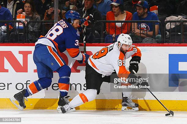 Bracken Kearns of the New York Islanders battles for the puck against Sam Gagner of the Philadelphia Flyers during the game at the Barclays Center on...