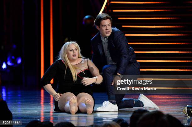 Actress Rebel Wilson and actor Adam DeVine accept the Best Kiss award for 'Pitch Perfect 2' onstage during the 2016 MTV Movie Awards at Warner Bros....