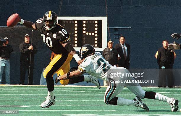 Pittsburgh Steelers' Quarterback, Kordell Stewart scrambles to avoid getting sacked by Jacksonville Jaguars' Aaron Beasley, in the 2nd quarter of...