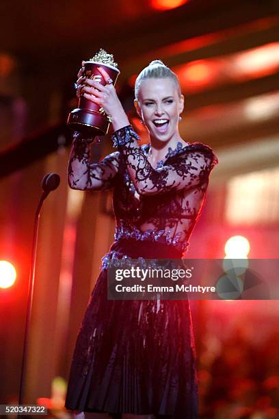 Actress Charlize Theron accepts Best Female Performance for 'Mad Max: Fury Road' onstage during the 2016 MTV Movie Awards at Warner Bros. Studios on...