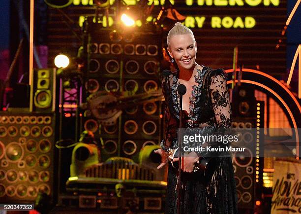 Actress Charlize Theron accepts the Best Female Performance award for 'Mad Max: Fury Road' onstage during the 2016 MTV Movie Awards at Warner Bros....