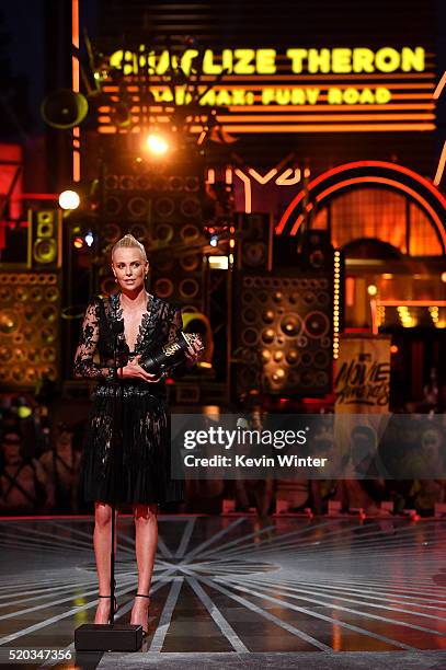Actress Charlize Theron accepts Best Female Performance for 'Mad Max: Fury Road' onstage during the 2016 MTV Movie Awards at Warner Bros. Studios on...