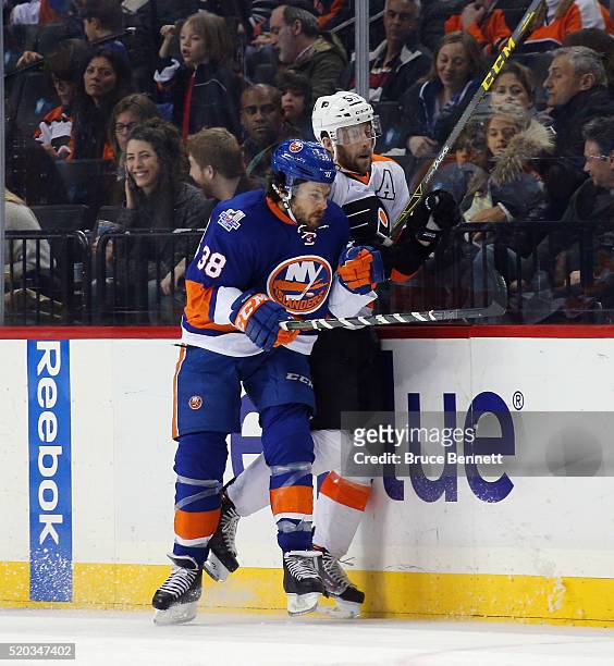 Bracken Kearns of the New York Islanders hits Nick Schultz of the Philadelphia Flyers during the third period at the Barclays Center on April 10,...