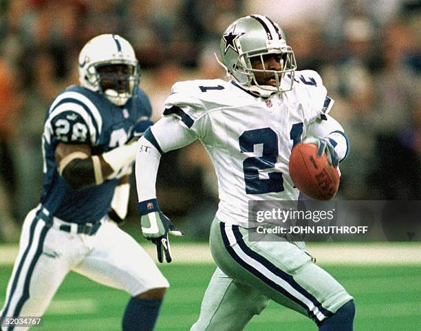 Dallas Cowboys cornerback Deion Sanders outdistances Indianapolis Colts defensive back Tito Wooten to score a touchdown in the first quarter of their...