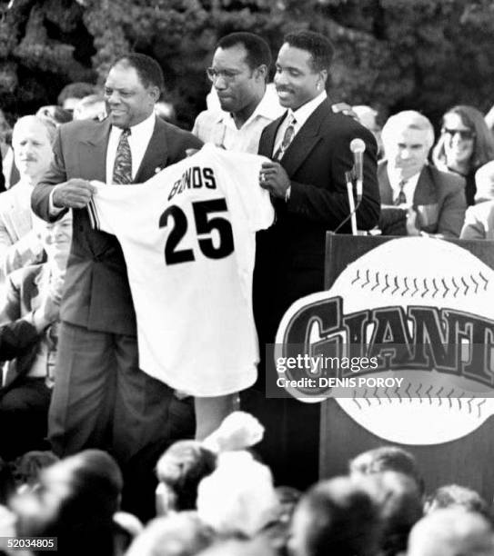 This 16 December 1992 file photo shows San Francisco Giants baseball greats Willie Mays , Bobby Bonds and Bonds' son Barry Bonds holding up the No....