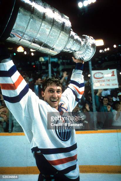 Wayne Gretzky of the Edmonton Oilers recieves the Stanley Cup Trophy after the Oilers defeated the Philadelphia Flyers in Game 7 of the 1987 Stanley...