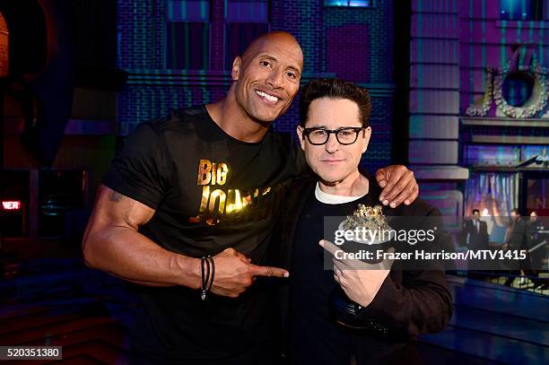 Co-host Dwayne Johnson and director J.J. Abrams, winner of the Movie of the Year award for 'Star Wars: The Force Awakens,' pose during the 2016 MTV...