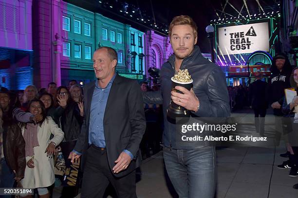 Actor Woody Harrelson presents actor Chris Pratt with the Best Action Performance Award "Jurassic World" onstage during the 2016 MTV Movie Awards at...