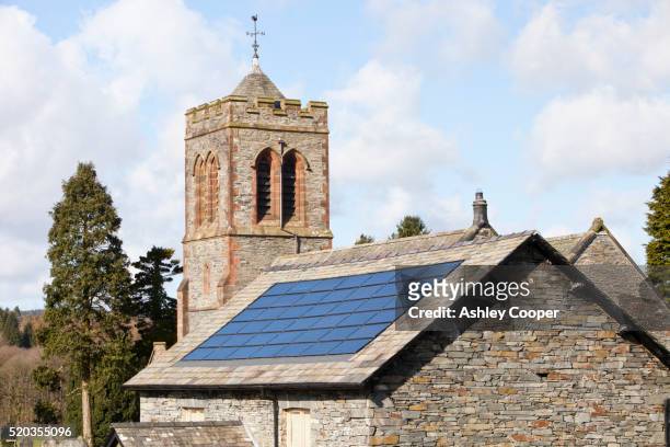 solar electric panels on lowick village hall in south cumbria, uk. - kirche stock-fotos und bilder