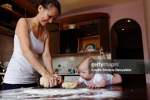 mother and daughter cooking dough - rosh hashanah stock pictures, royalty-free photos & images