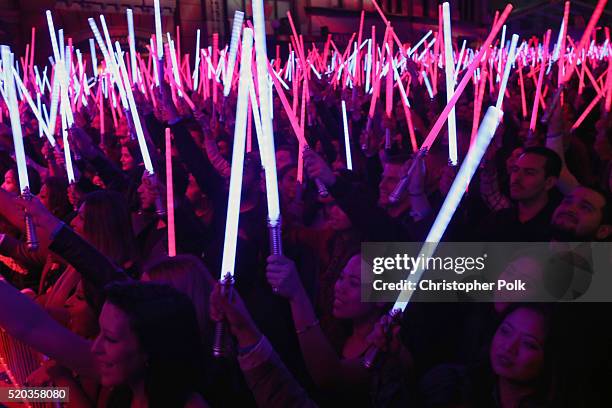Audience holds up lightsabers during the announcement of 'Star Wars:The Force Awakens' as the Movie of the Year winner during the 2016 MTV Movie...