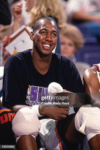 Danny Manning of the Phoenix Suns smiles from the bench during an NBA game against the Atlanta Hawks on October 30, 1994 at America West Arena in...