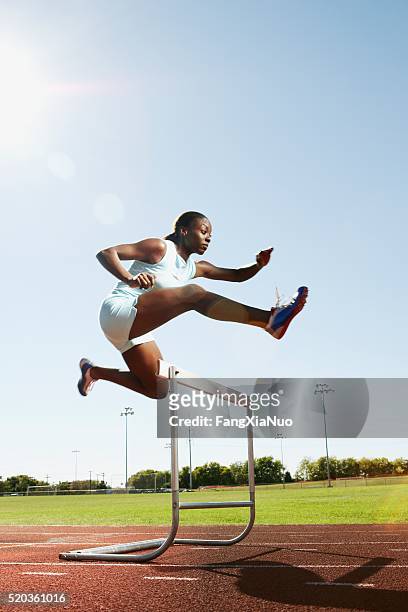 hurdler in air - forward athlete stockfoto's en -beelden