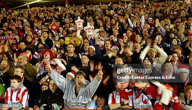 Fans cheer during the FA Cup Third Round replay between Exeter City and Manchester United at St James Park January 19, 2005 in Exeter, England.