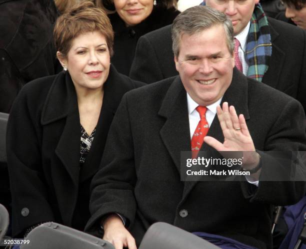 Florida Gov. Jeb Bush and his wife Columba wave to the crowd as they are seated on the inaugural stage January 20, 2005 in Washington, D.C. U.S....