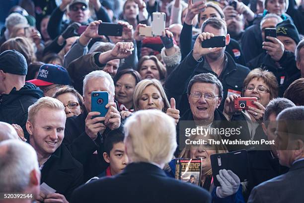 Supporters reach for handshakes, signatures, and photos as republican presidential candidate Donald Trump greets the crowd after speaking during a...