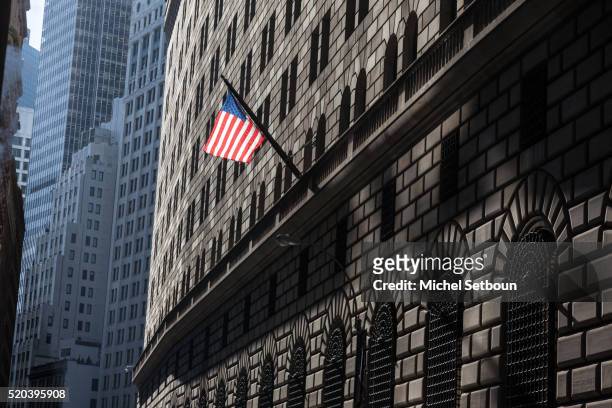 american flag on the federal reserve bank building - us federal reserve building stock pictures, royalty-free photos & images