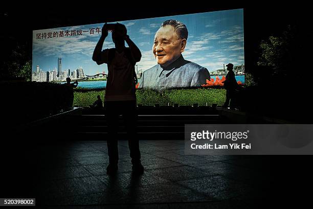 The billboard of Deng Xiaoping, the former Chinese leader who advocates One Country, Two Systems, stands at the Lo Wu border on April 3, 2016 in...