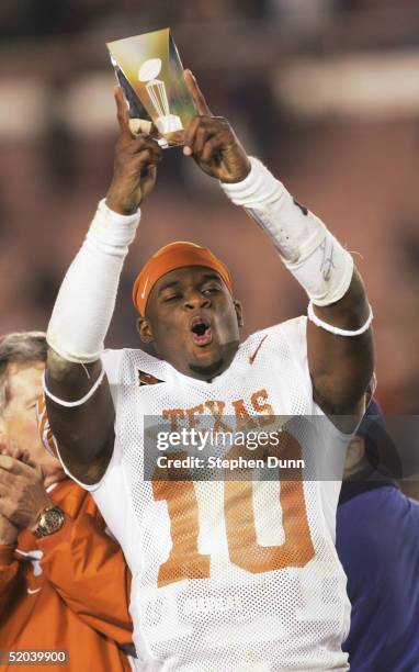 Quarterback Vince Young of the Texas Longhorns celebrates victory with the MVP trophy after defeating the Michigan Wolverines in the 91st Rose Bowl...