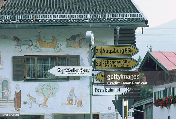 signs in front of building mural - oberammergau stock pictures, royalty-free photos & images