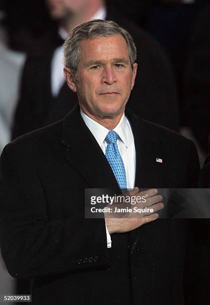 President George W. Bush watches the inaugural parade from the Presidential reviewing stand in front of the White House January 20, 2005 in...