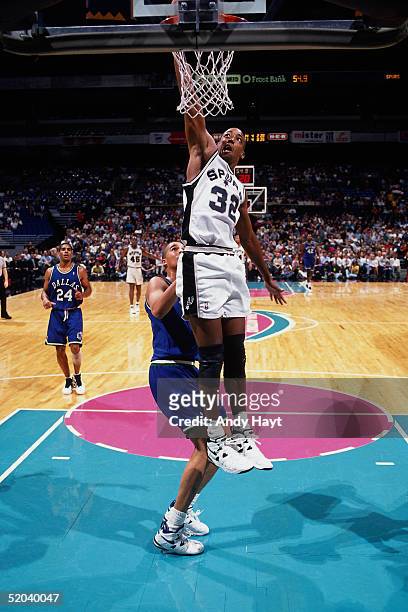 Sean Elliott of the San Antonio Spurs goes for a dunk against the Dallas Mavericks during the NBA game on December 6, 1994 in San Antonio, Texas....
