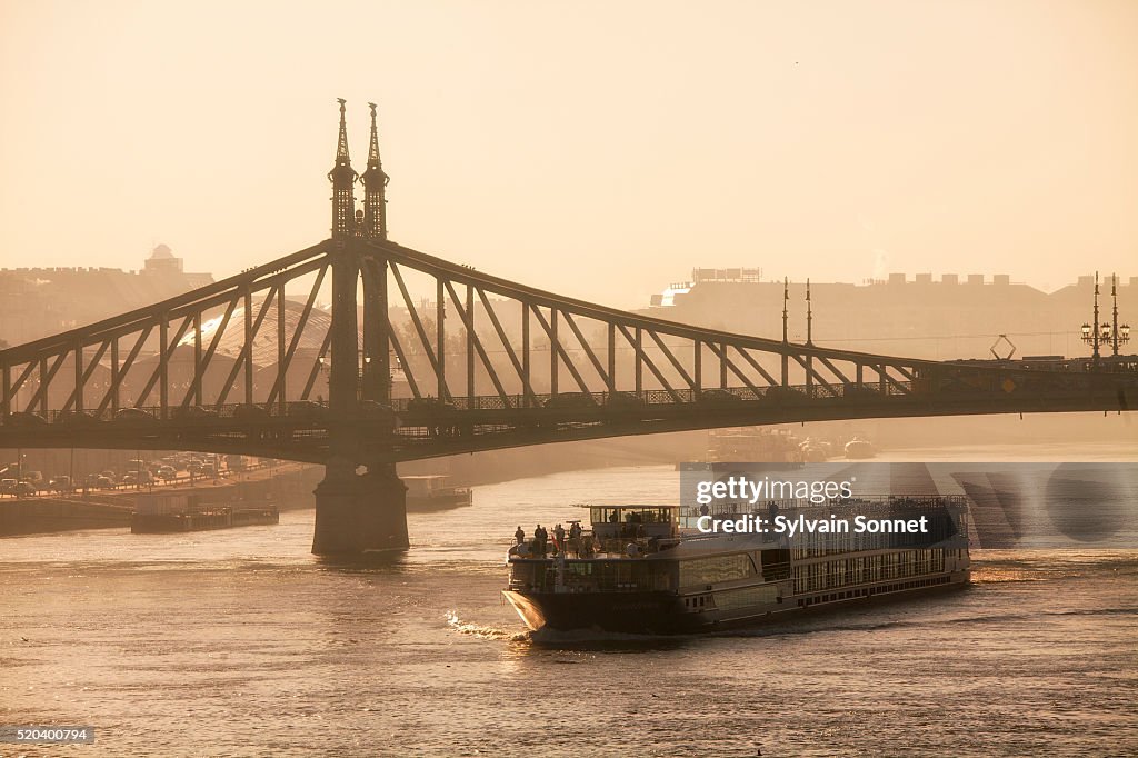Budapest, Tour Boat on Danube River and Freedom Bridge at Sunris