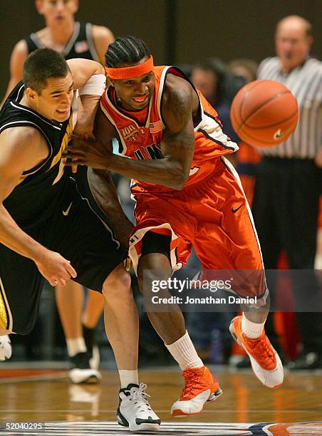 Dee Brown of the Illinois Fighting Illini and Jeff Horner of the Iowa Hawkeyes chase down a loose ball on January 20, 2005 at the Assembly Hall at...