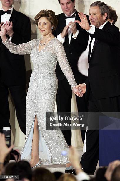 President George W. Bush and first lady Laura acknowledge the crowd at the Freedom Ball January 20, 2005 at Union Station in Washington, DC. Bush was...
