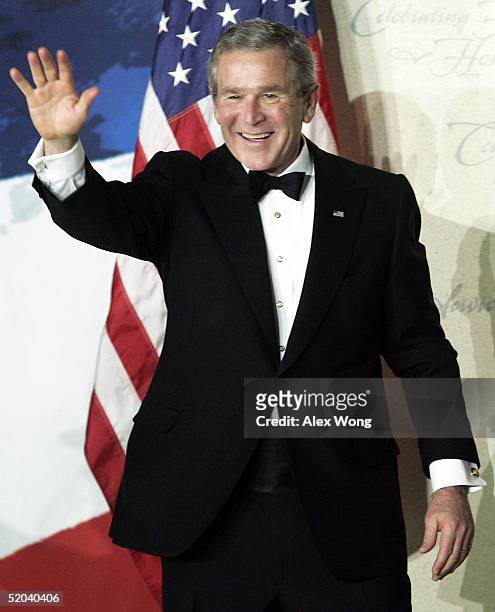 President George W. Bush acknowledges the crowd at the Freedom Ball January 20, 2005 at Union Station in Washington, DC. Bush was sworn in for his...