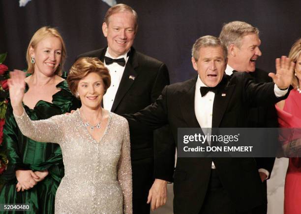 President George W. Bush with his wife Laura wave to the crowd with New York Governor George Pataki and his wife Libby at the Stars and Stripes...