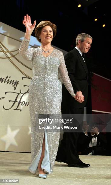 President George W. Bush and his wife Laura walk onto the stage at the Stars And Stripes Ball January 20, 2005 in Washington, DC. Bush was...
