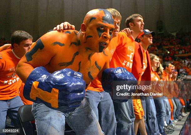 Ceasar Perez, a fan of the Illinois Fighting Illini, joins other students as they sway during player introductions before a game against the Iowa...