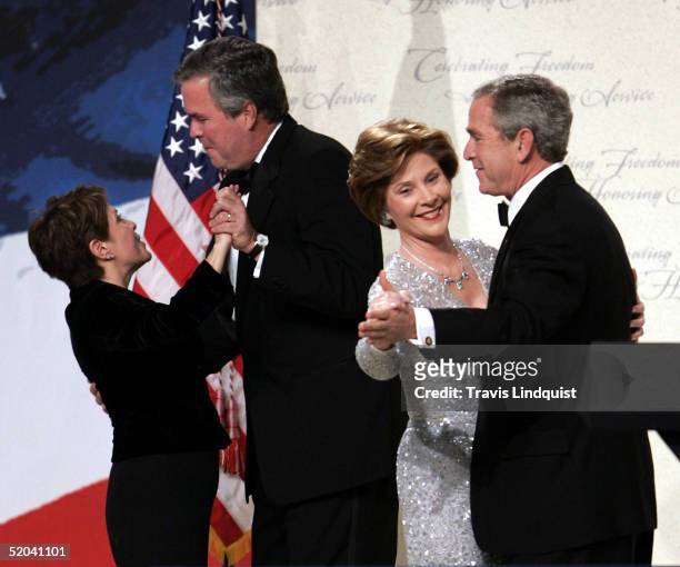 President George W. Bush dances with first lady Laura Bush as his brother Jeb Bush dances with his wife Columba at the Liberty Ball inside the...