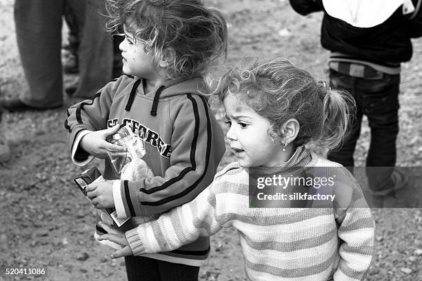 refugee sisters in food line - quiosque stock pictures, royalty-free photos & images