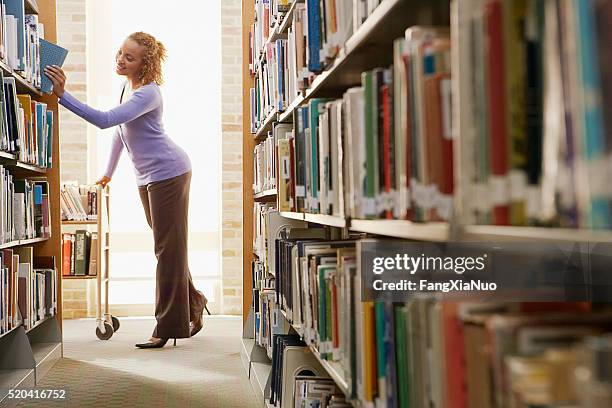 librarian re-shelving books - librarian stock pictures, royalty-free photos & images