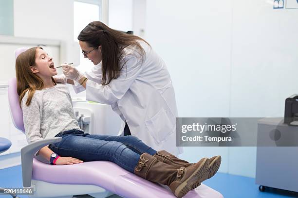 young girl at the dentist. - pediatric dentistry stock pictures, royalty-free photos & images